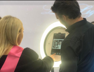 Couple-Standing-in-front-of-photobooth