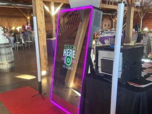 A mirror booth with a purple light