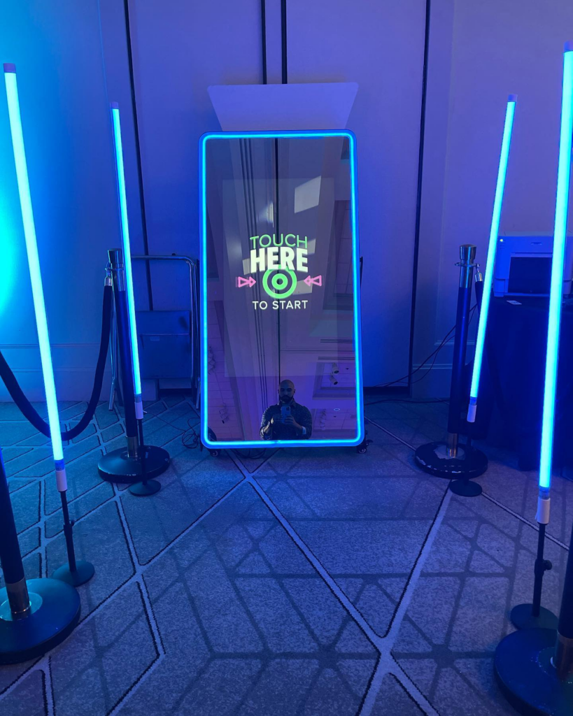 guests enjoying a photobooth experience at a corporate event with branded entertainment setup